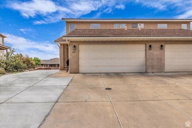 1277 W Las Hurdes Dr, St George, UT 84770 - view of front facade with concrete driveway, a tiled roof, a garage, and stucco siding