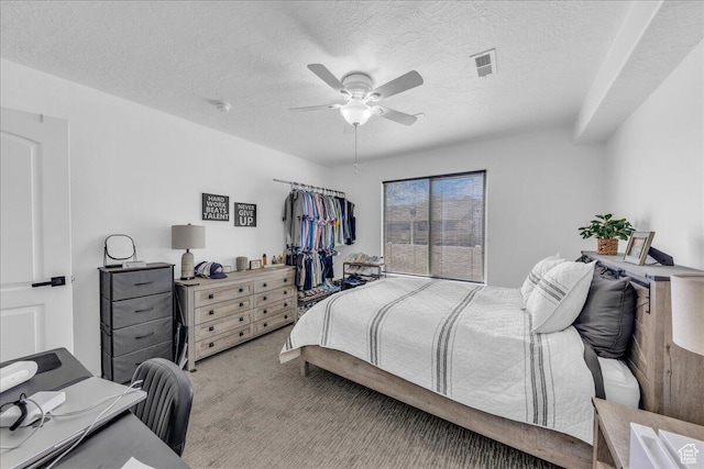1277 W Las Hurdes Dr, St George, UT 84770 - bedroom with visible vents, light colored carpet, a ceiling fan, and a textured ceiling