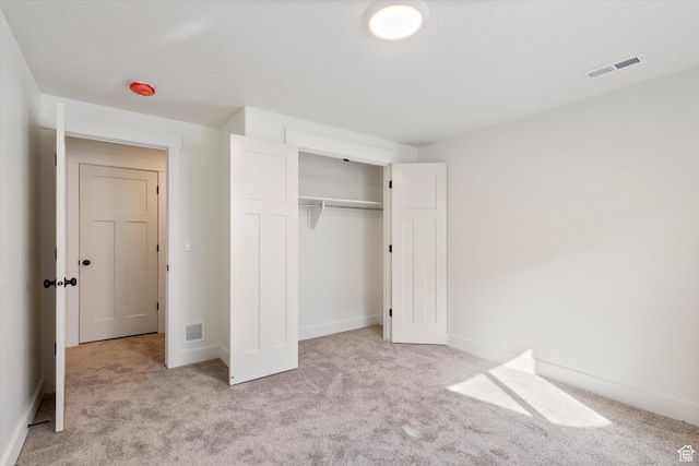 unfurnished bedroom with visible vents, baseboards, a closet, and carpet floors