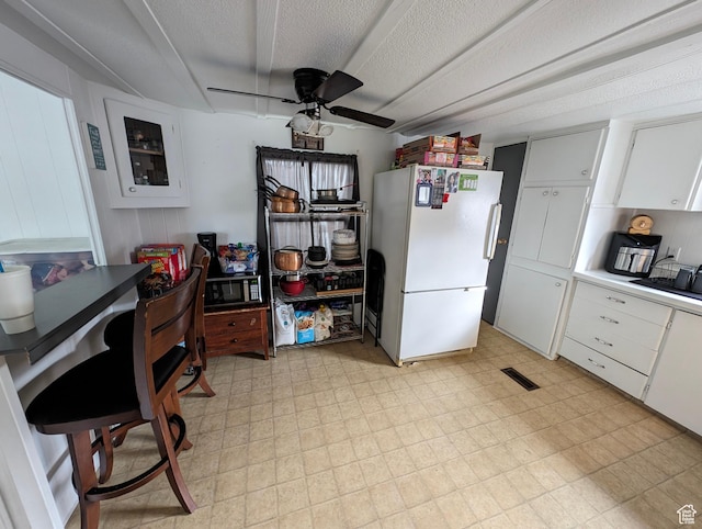 160 W 800 S, Payson, UT 84651 - kitchen with white cabinetry, freestanding refrigerator, light floors, and a ceiling fan