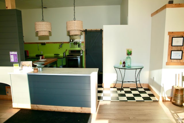 510 N Main St, Henefer, UT 84033 - kitchen with a barn door, stove, a peninsula, and decorative light fixtures