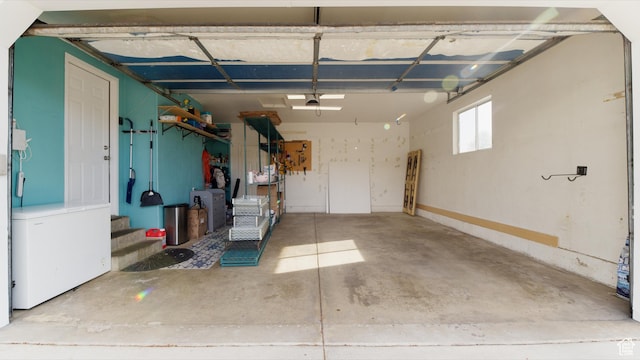 garage with refrigerator and a garage door opener