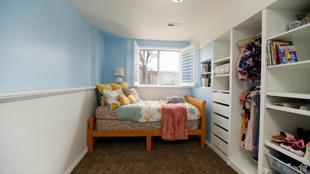bedroom with visible vents and carpet