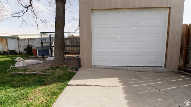 garage with driveway and fence