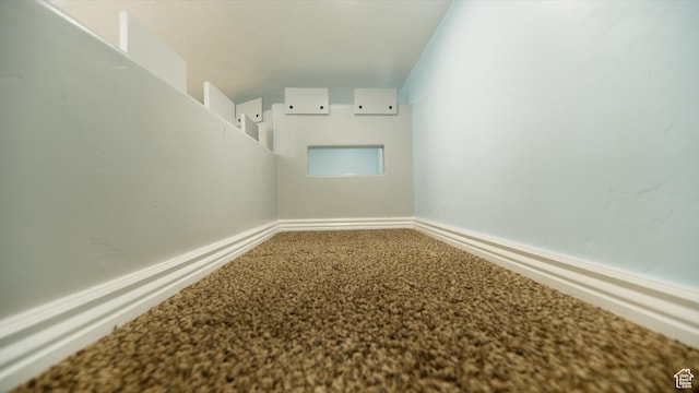 carpeted spare room with baseboards