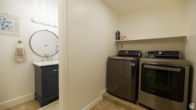 laundry room with light tile patterned flooring, laundry area, washing machine and clothes dryer, and baseboards