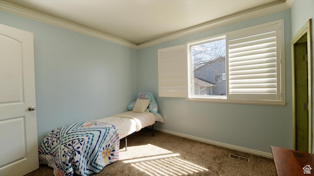 carpeted bedroom with visible vents, baseboards, and crown molding
