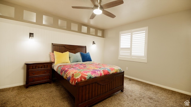 carpeted bedroom featuring baseboards and ceiling fan