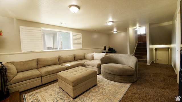 carpeted living room featuring a textured ceiling, visible vents, and stairway