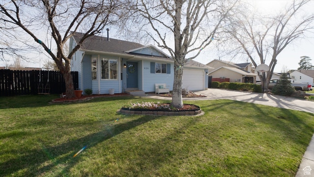 view of front of property with an attached garage, fence, a front lawn, and concrete driveway