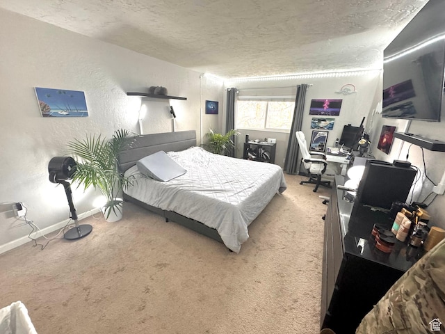 bedroom featuring a textured wall, a textured ceiling, baseboards, and carpet floors