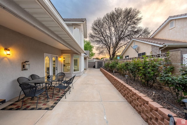 827 E 1070 S, St George, UT 84790 - patio terrace at dusk featuring french doors, a fenced backyard, and outdoor dining area