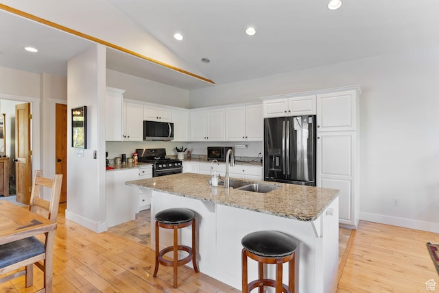 1036 Station Loop Rd, Park City, UT 84098 - kitchen featuring light wood-style floors, a sink, white cabinetry, and stainless steel appliances