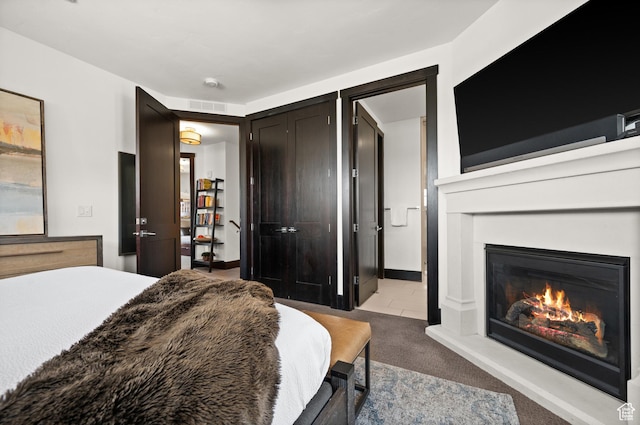 3700 Blackstone Dr Unit 9, Park City, UT 84098 - bedroom featuring a glass covered fireplace, carpet flooring, and visible vents