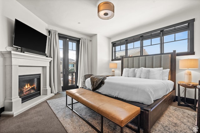 3700 Blackstone Dr Unit 9, Park City, UT 84098 - carpeted bedroom with a glass covered fireplace, multiple windows, and access to exterior