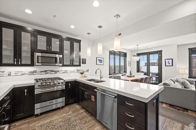 3700 Blackstone Dr Unit 9, Park City, UT 84098 - kitchen with a sink, open floor plan, a peninsula, wood finished floors, and stainless steel appliances