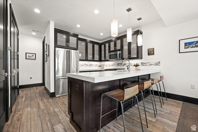 3700 Blackstone Dr Unit 9, Park City, UT 84098 - kitchen featuring tasteful backsplash, a peninsula, a breakfast bar area, stainless steel appliances, and a sink