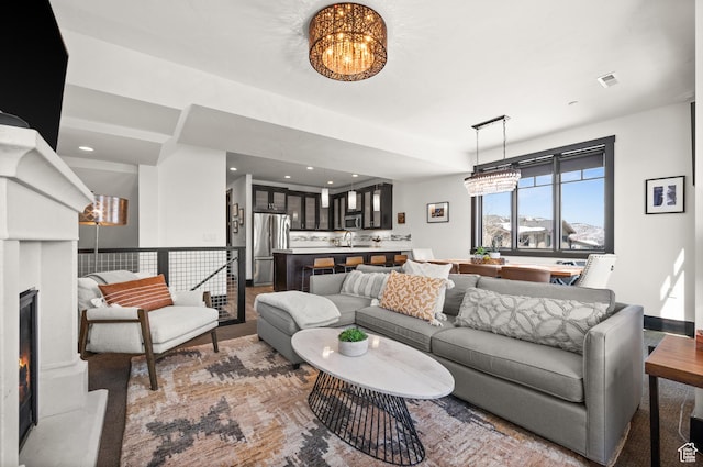3700 Blackstone Dr Unit 9, Park City, UT 84098 - living area featuring visible vents, an inviting chandelier, a warm lit fireplace, and recessed lighting
