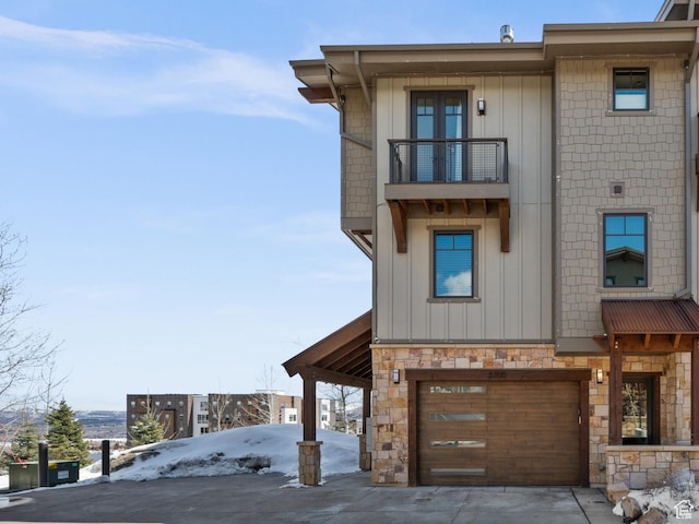 3700 Blackstone Dr Unit 9, Park City, UT 84098 - view of front of property featuring board and batten siding, a garage, stone siding, and a balcony