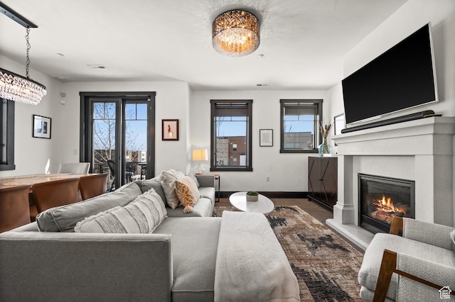 3700 Blackstone Dr Unit 9, Park City, UT 84098 - living room featuring visible vents, baseboards, a chandelier, and a glass covered fireplace