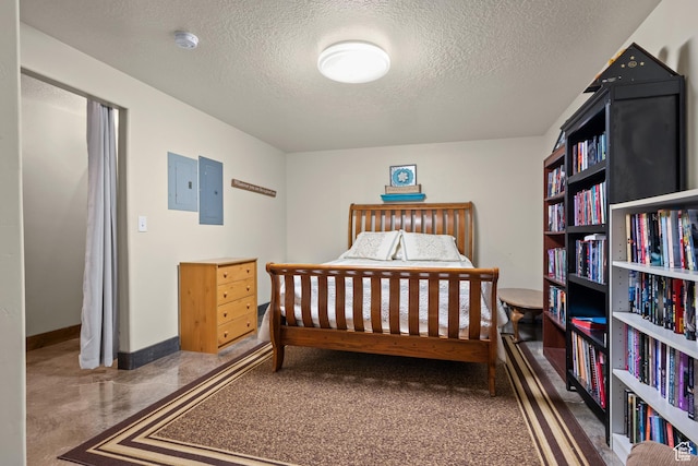 bedroom with baseboards, electric panel, and a textured ceiling