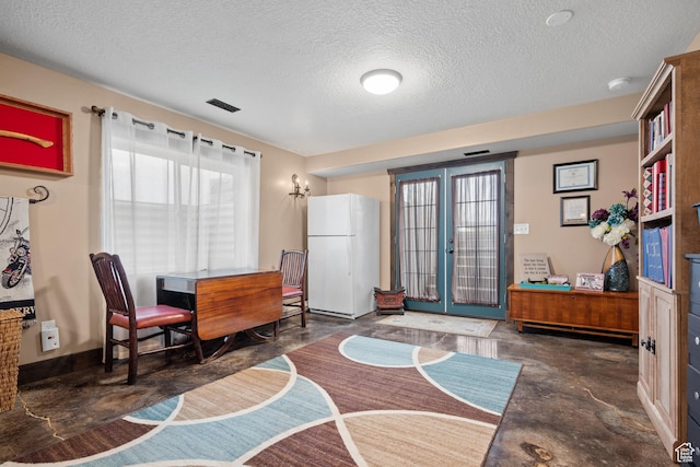 dining room featuring a textured ceiling, concrete flooring, visible vents, french doors, and baseboards