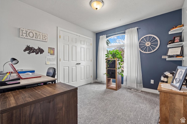 carpeted office with baseboards and visible vents