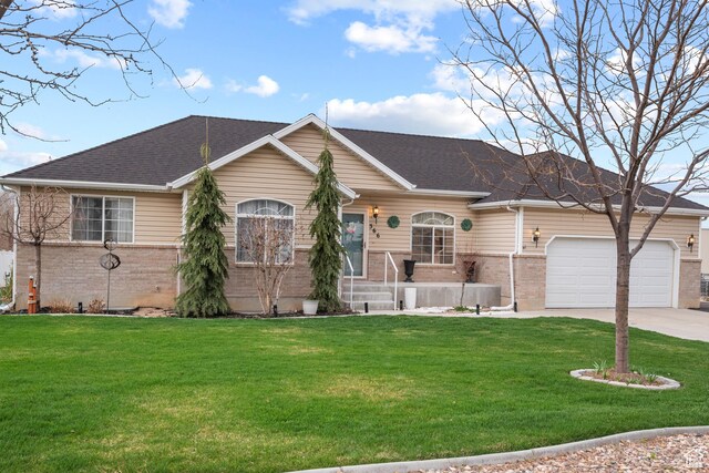 ranch-style house featuring a garage, brick siding, driveway, and a front lawn