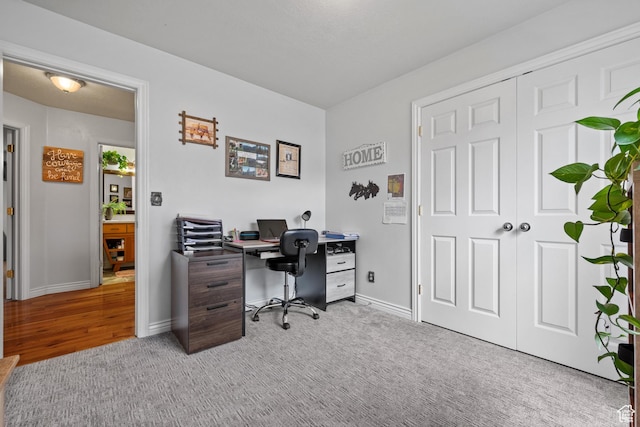 office area with light colored carpet and baseboards