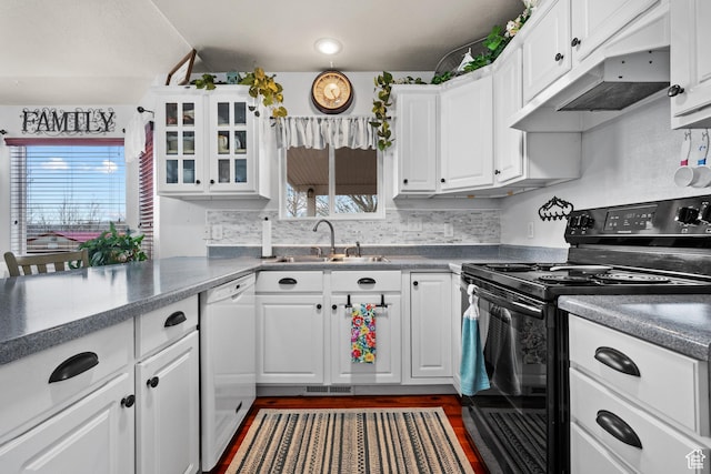 kitchen featuring white cabinets, a sink, white dishwasher, and black / electric stove