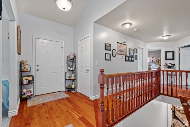entrance foyer featuring baseboards and light wood-type flooring