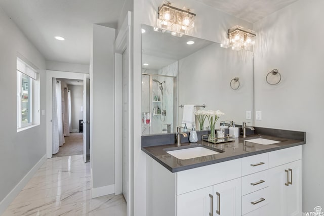 full bathroom featuring a chandelier, a shower stall, marble finish floor, and a sink