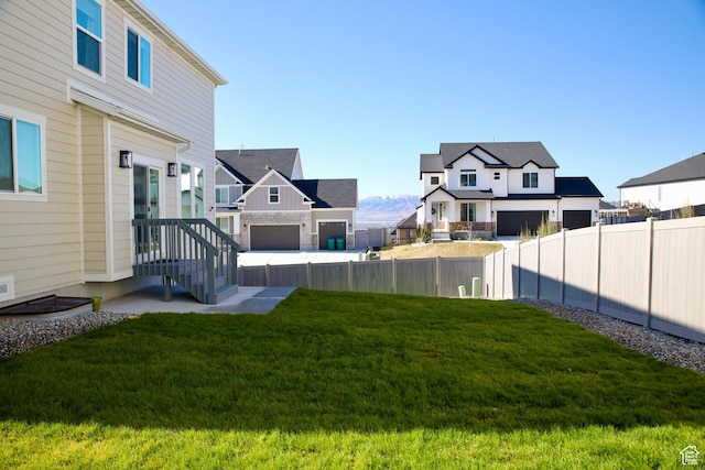 view of yard featuring a residential view and fence