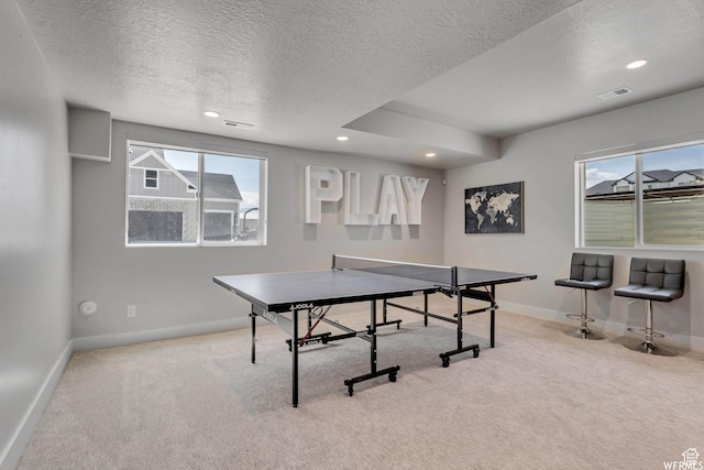playroom with a wealth of natural light, carpet flooring, visible vents, and baseboards