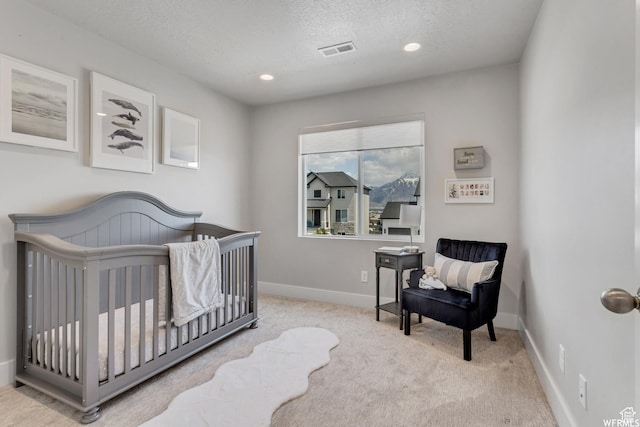 bedroom with baseboards, recessed lighting, a textured ceiling, carpet floors, and visible vents