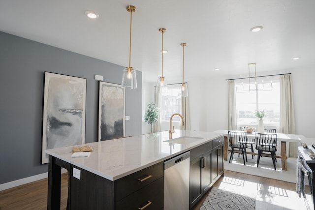 kitchen featuring appliances with stainless steel finishes, wood finished floors, a sink, and a healthy amount of sunlight