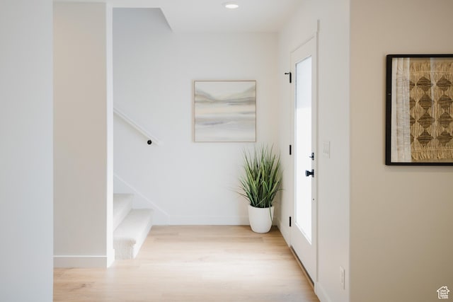 foyer entrance with wood finished floors, recessed lighting, baseboards, and stairway