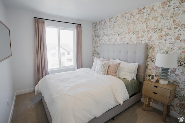 carpeted bedroom with wallpapered walls and baseboards