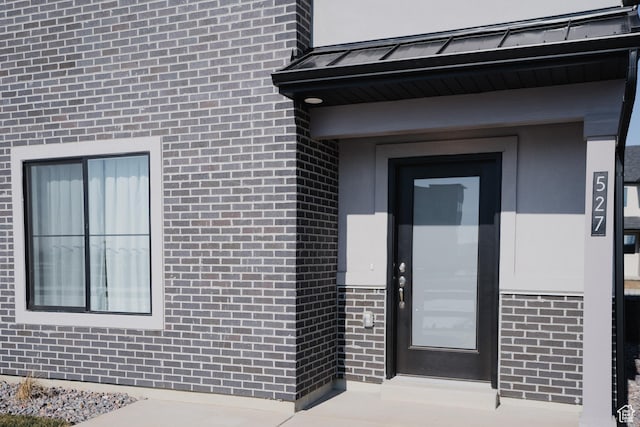 property entrance with brick siding