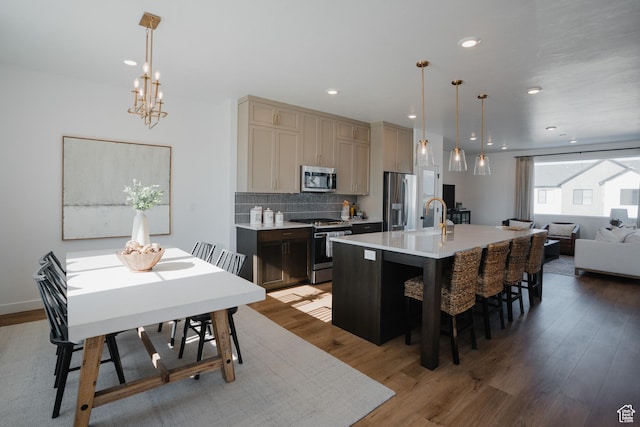 dining room featuring recessed lighting, a notable chandelier, and wood finished floors