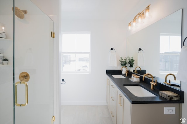 full bathroom with a shower stall, a sink, and plenty of natural light