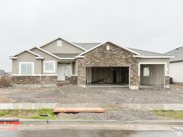 craftsman-style house with stone siding, a garage, stucco siding, and a shingled roof