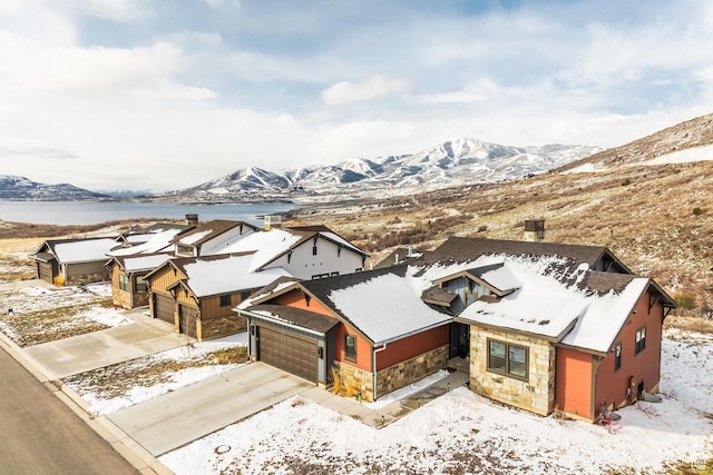 snowy aerial view featuring a mountain view