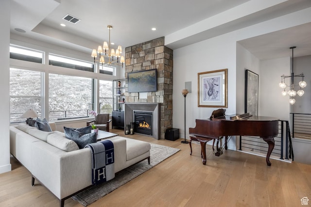 12709 N Belaview Way, Hideout, UT 84036 - living area with visible vents, a notable chandelier, a fireplace, recessed lighting, and wood finished floors
