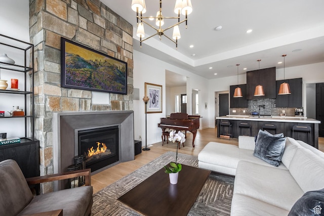 12709 N Belaview Way, Hideout, UT 84036 - living area featuring recessed lighting, a fireplace, light wood finished floors, and an inviting chandelier