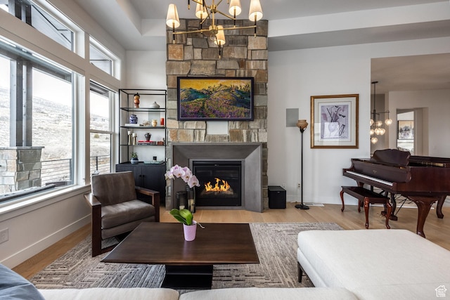 12709 N Belaview Way, Hideout, UT 84036 - living room with baseboards, a large fireplace, an inviting chandelier, and wood finished floors