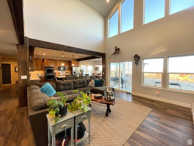 3525 S Sweetwater Pkwy, Garden City, UT 84028 - living room featuring dark wood-style floors and a towering ceiling
