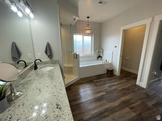 3525 S Sweetwater Pkwy, Garden City, UT 84028 - full bath featuring a garden tub, a shower stall, wood finished floors, and vanity