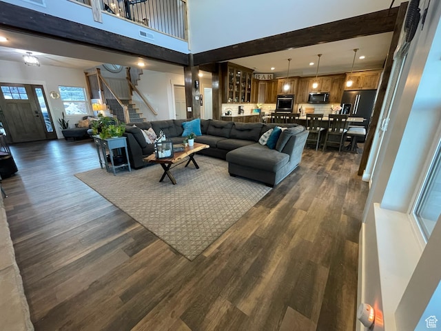 3525 S Sweetwater Pkwy, Garden City, UT 84028 - living area featuring stairs, dark wood-style flooring, recessed lighting, a high ceiling, and beam ceiling