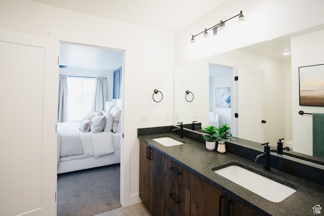 ensuite bathroom featuring a sink, double vanity, and ensuite bath